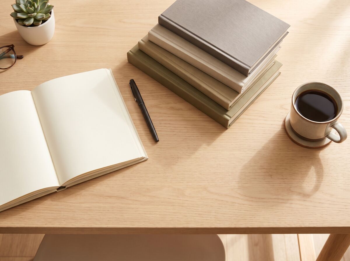 Stack of business handbooks on a desk